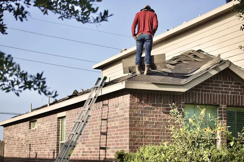 Professional roofer working on a residential roof in Stone Hill Farms